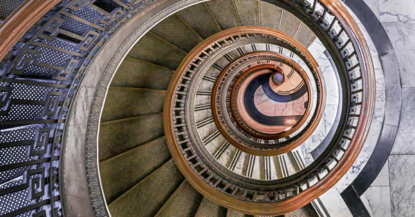 View of spiral stairway looking down center from top floor